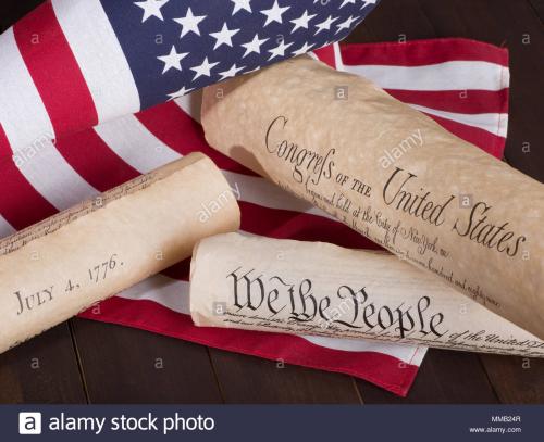 historical-american-documents-declaration-of-independence-constitution-and-bill-of-rights-with-the-united-states-flag-MMB24R