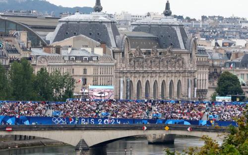 Spectators on a bridge over the River Seine during the opening ceremony of the Paris 2024 Olympic Games Paris