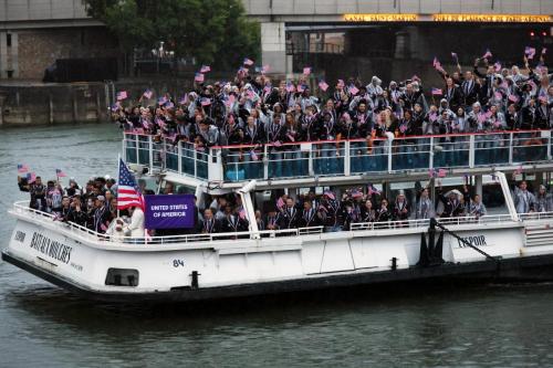 hletes of Team United States wave flags on the athletes' parade team boat along the River Seine during the opening ceremony of the Olympic Games Paris 2024